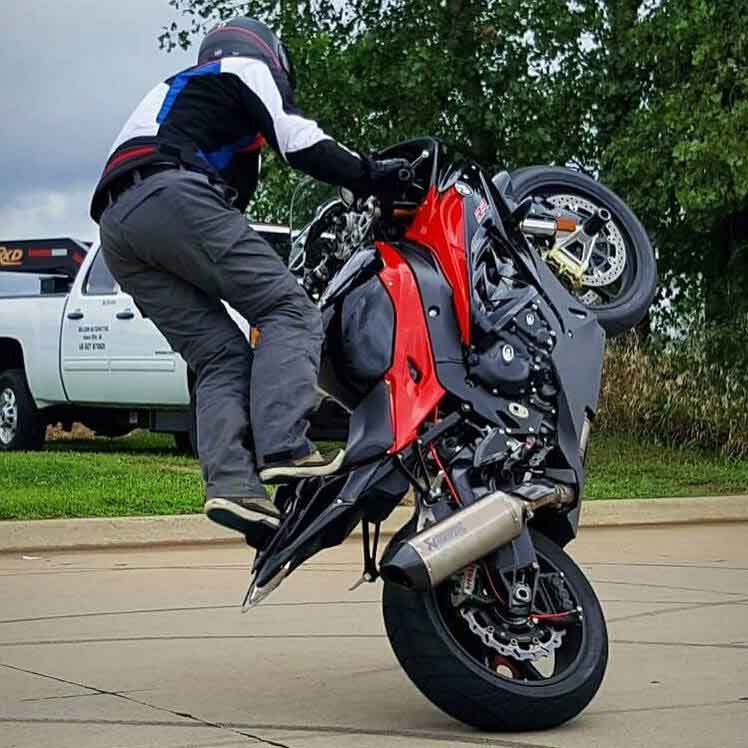Teach McNeil stunts on a BMW motorcycle.